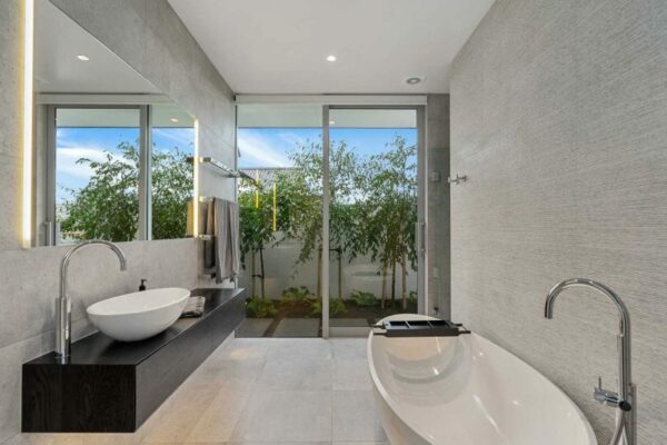 Luxurious tiled bathroom with freestanding tub and dual vanities, designed and built by Stanton Builders—leaders in home renovation and bathroom transformations in Christchurch.