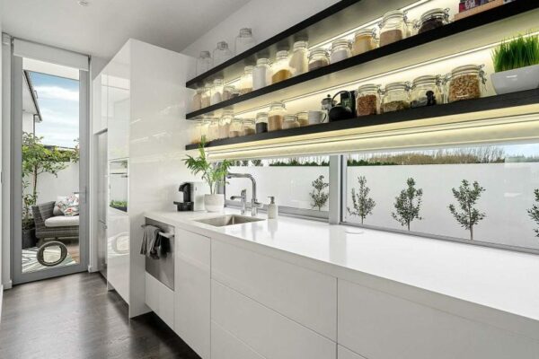 Sleek, modern scullery with minimalist cabinetry and floating shelves—crafted by expert renovation builders at Stanton Builders in Canterbury.