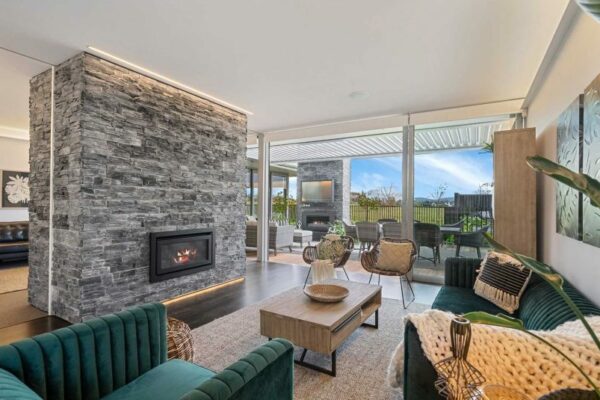 Contemporary living room with a modern fireplace and indoor-outdoor flow, built by Stanton Builders—Christchurch’s trusted master builders for high-end renovations and bespoke homes.