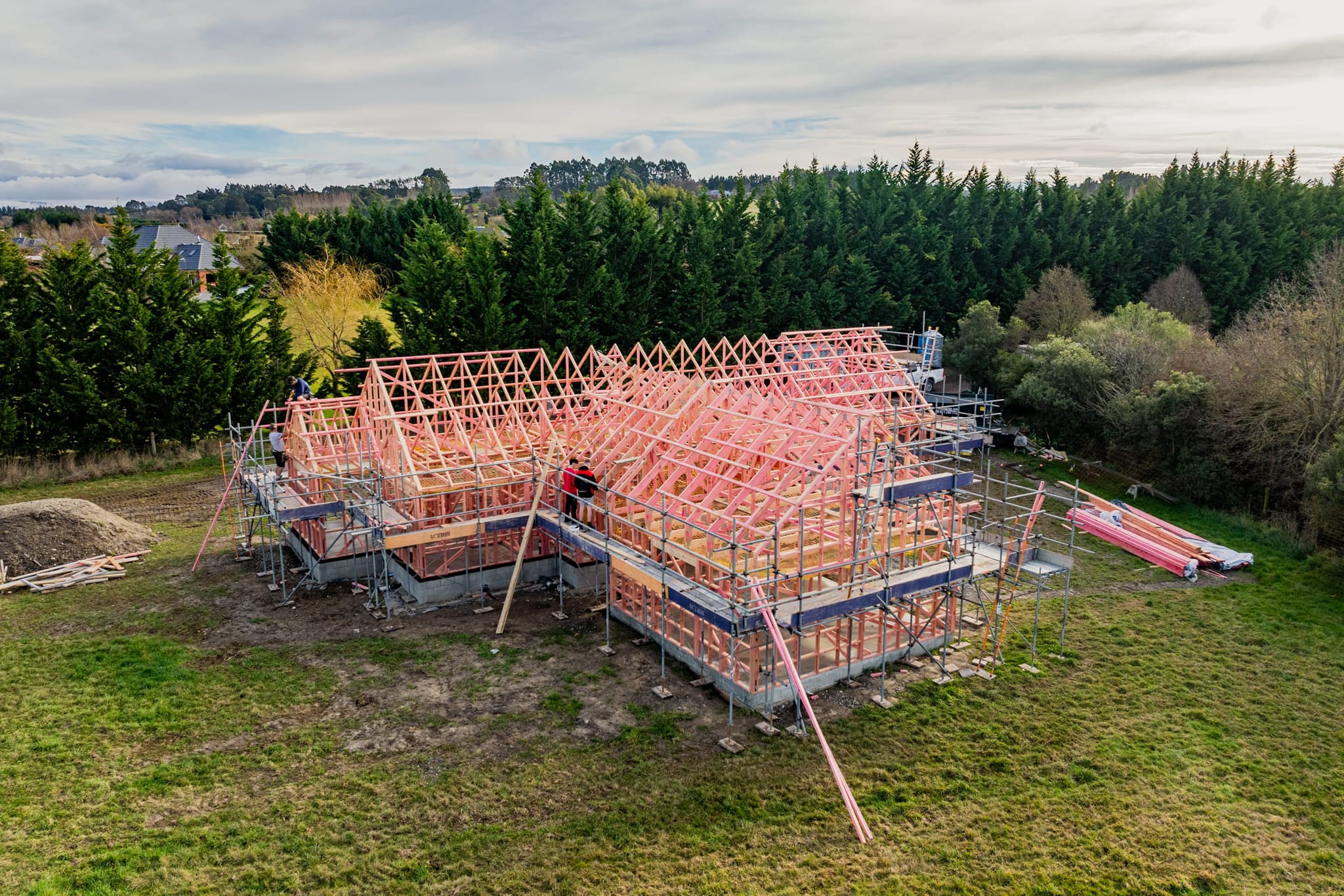 Home builders working on roof framing for a custom kitchen and bathroom renovation project.